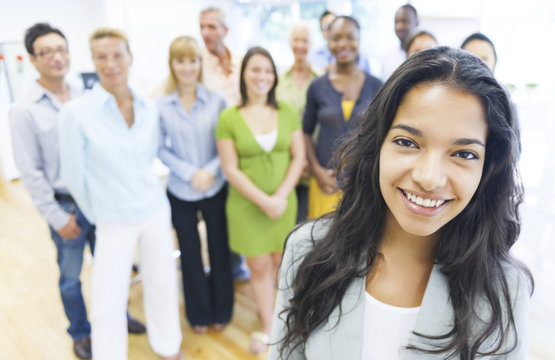 young woman with colleagues in the background