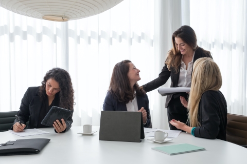 Woman speaking with colleagues